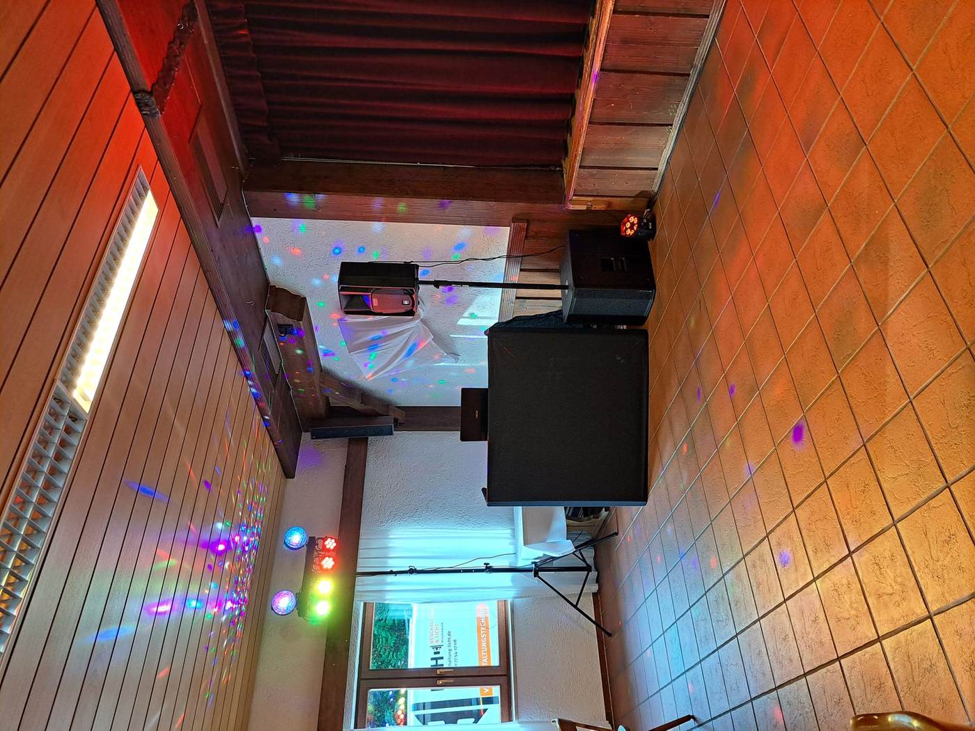 DJ-Pult mit Lichteffekten in gemütlicher Location
