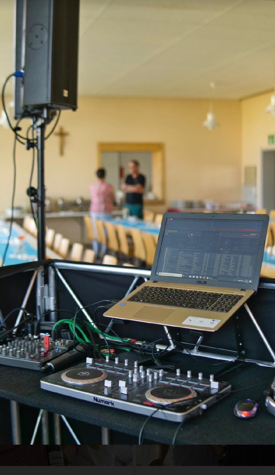 DJ-Setup: DJ-Controller, Mischpult und Lautsprecher in festlichem Raum