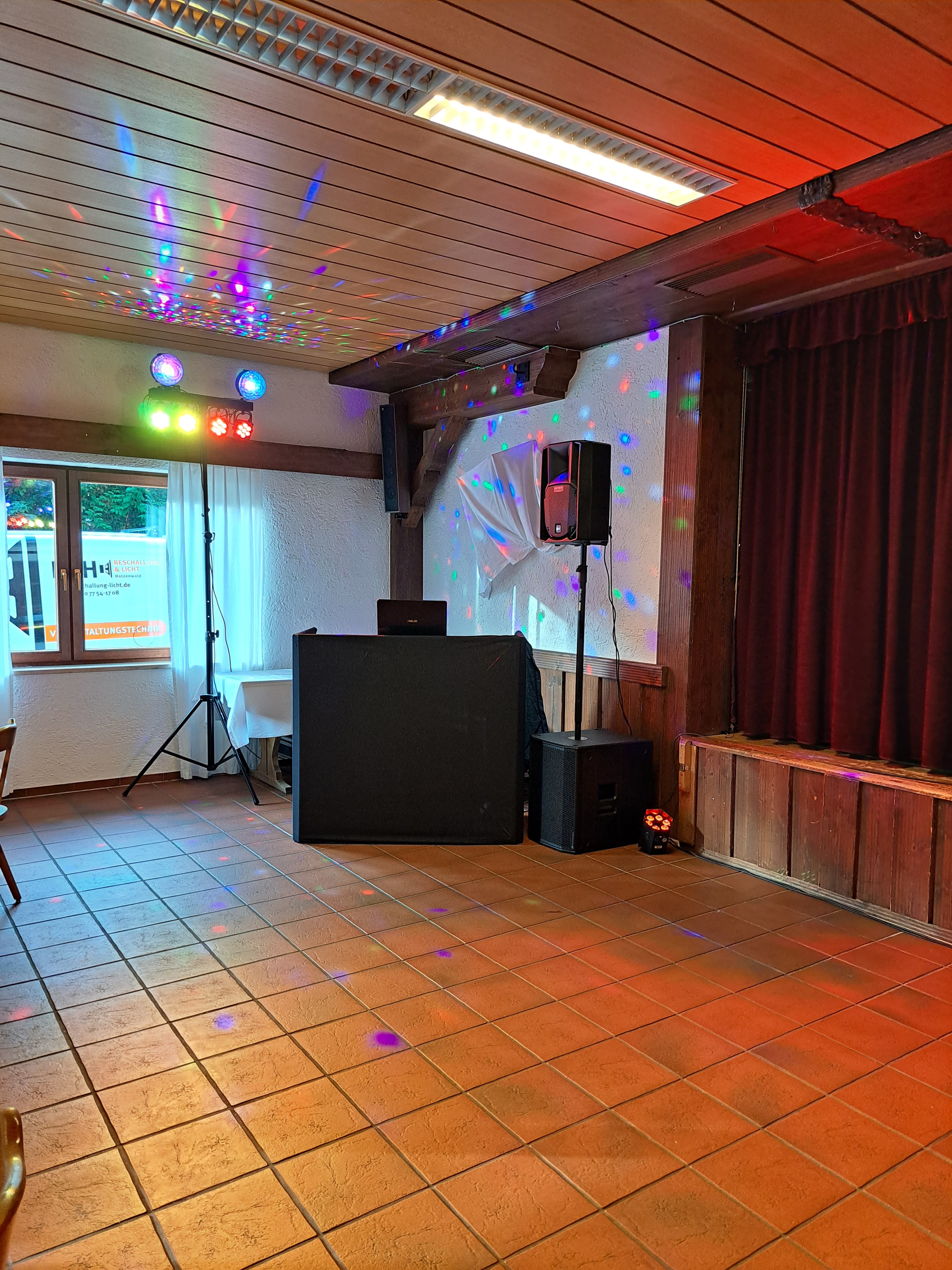 DJ-Pult mit Lichteffekten in gemütlicher Location